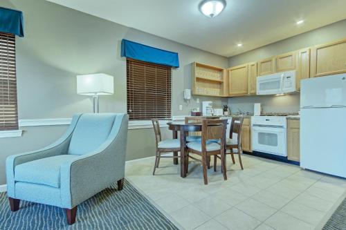 a kitchen with a table and chairs and a refrigerator at Club Wyndham Bentley Brook in Hancock