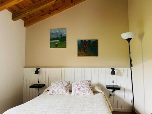 a bedroom with a bed with two pillows on it at El Hayuco de Montejo in Montejo de la Sierra