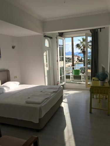 a bedroom with a bed and a view of the ocean at Göcekinn in Göcek