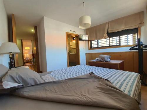 a bedroom with a large bed with a window at Casa da Padaria in Mondim de Basto