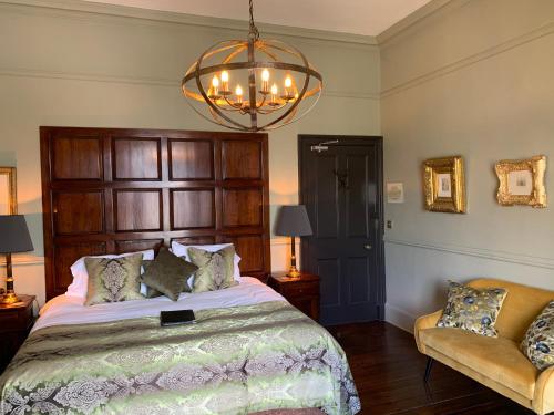 a bedroom with a large bed and a chandelier at 23 Mayfield in Edinburgh
