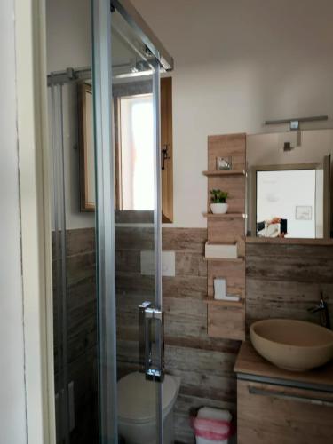a bathroom with a shower and a toilet and a sink at Il corallo rosso in Favignana