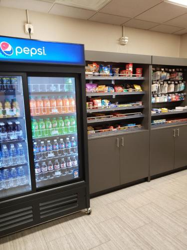 a soda machine in a store with lots of drinks at Wingate by Wyndham Coon Rapids in Coon Rapids