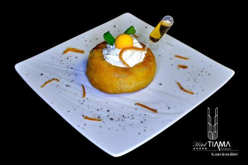 a white plate with a dessert on it at Hotel Tiama Abidjan in Abidjan