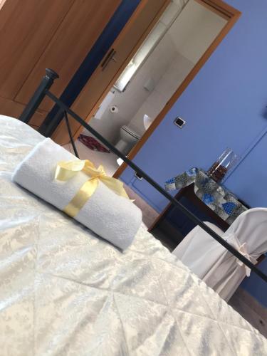 a bedroom with a bed with a yellow ribbon on it at Hotel Degli Amici in Sant'Egidio del Monte Albino