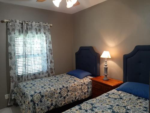 - une chambre avec 2 lits et une fenêtre dans l'établissement AIRBAB Moon Gate West, à Mount Pleasant