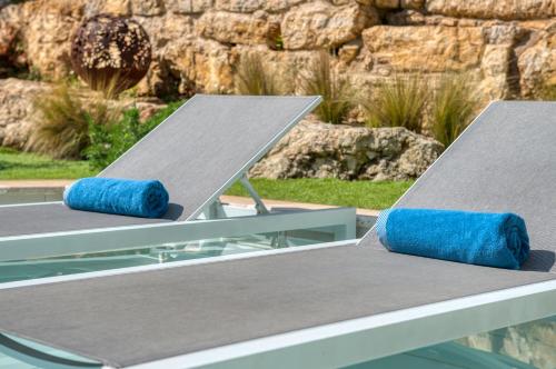 two picnic tables with blue pillows sitting on them at la villa miel in Opio