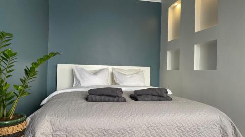 a bedroom with a bed with two pillows on it at City Ocean apartment in Daugavpils