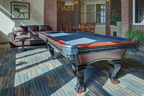 a pool table in a living room with a couch at Club Wyndham Durango in Durango