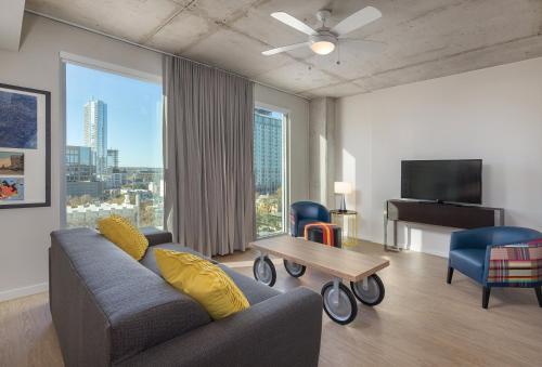 a living room with a couch and a table and a piano at Club Wyndham Austin in Austin
