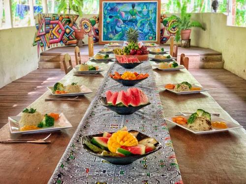 a long table with plates of food on it at Katari Center in Tarapoto