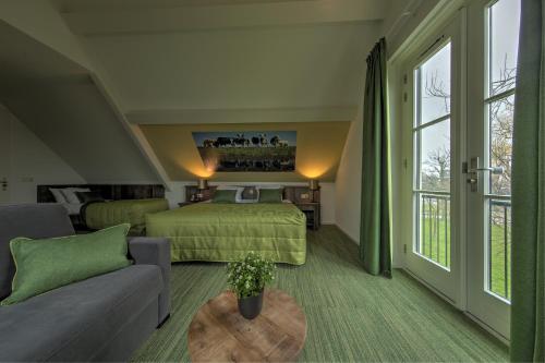 um quarto de hotel com uma cama e um sofá em De Willigen Logies em Vreeland