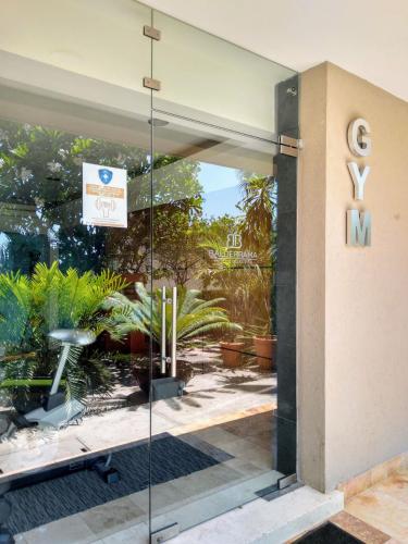 a glass door of a building with a sign on it at Hotel San Luis Lindavista in Culiacán