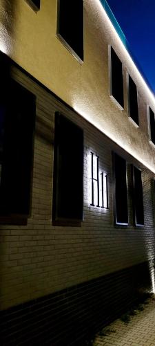 a brick building with windows on the side of it at H11 Downtown Apartments in Târgu-Mureş