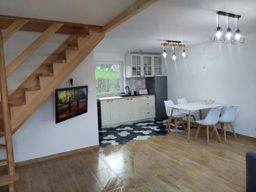 a kitchen and dining room with a table and chairs at HEXAGON HONEY HOUSE+ prywatna plaża+jezioro+ stawy+ gospodarstwo+ pasieka in Srokowo