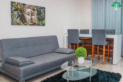 a living room with a couch and a table at Condominios Costa Diamante in San Carlos