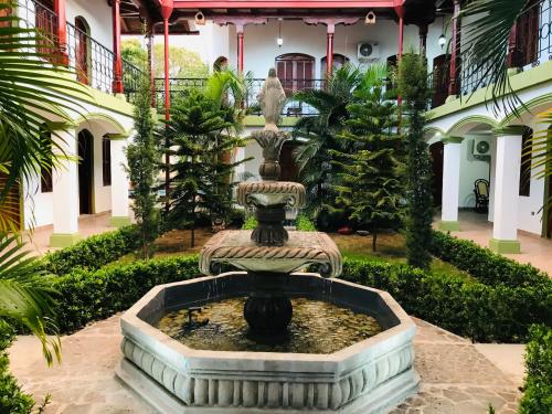 a fountain in the courtyard of a building at Hotel Torogoz in Granada