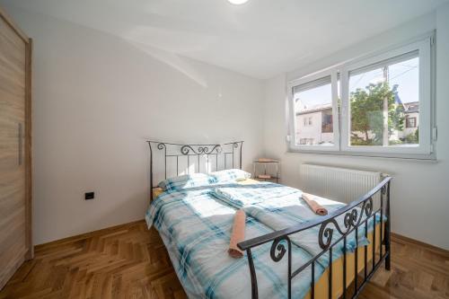 Posteľ alebo postele v izbe v ubytovaní Apartman Grand