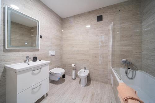 a bathroom with a sink and a toilet and a shower at Apartman Grand in Zagreb
