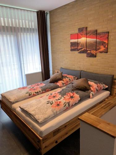 a large bed with flowers on it in a bedroom at Mariposa 5 incl Pool & Sauna in Bad Harzburg