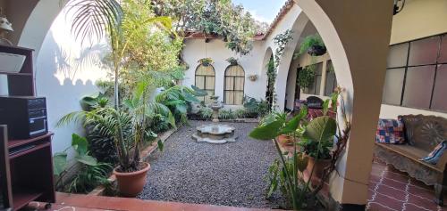 a room with a bunch of plants in it at Hotel Posada Santa Teresita in Antigua Guatemala