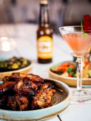 a table with a plate of food and a drink at The Victoria Hotel Bathurst in Bathurst