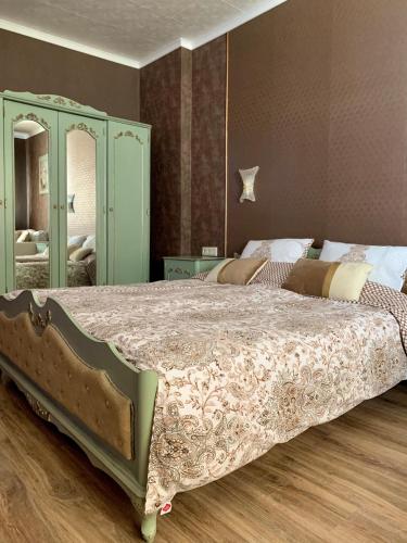 a bedroom with a large bed and a mirror at Boutique House Belevi in Nesebar