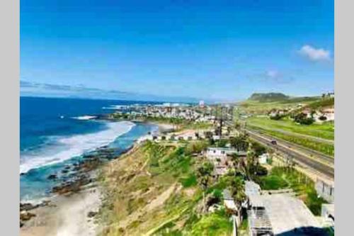 an aerial view of a beach next to the ocean at Beachfront Condo close Puerto Nuevo, Papas, and Valle de Guadalupe in Rosarito