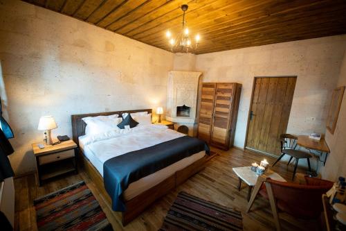 A bed or beds in a room at Duven Hotel Cappadocia