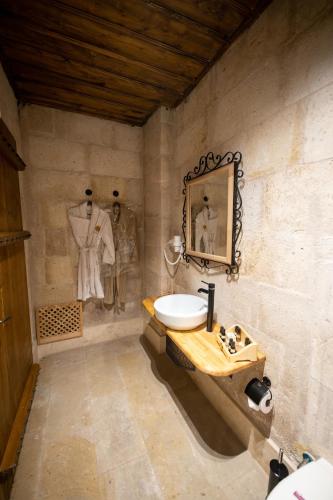 a bathroom with a sink and a mirror on the wall at Duven Hotel Cappadocia in Uchisar