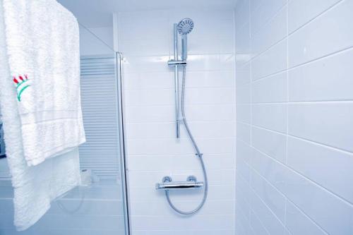 a bathroom with a shower with a glass door at Mills Apartment - Two bedroom en-suite apartment in Northampton