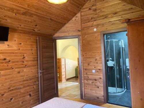 a room with wooden walls and a glass door at Adelis in Yaremche