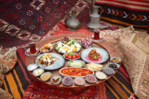 a table with plates of food on a table at Duven Hotel Cappadocia in Uchisar