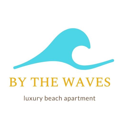 przy falach logo luksusowego sprzętu plażowego w obiekcie By the Waves luxury beach apartment w Warnie