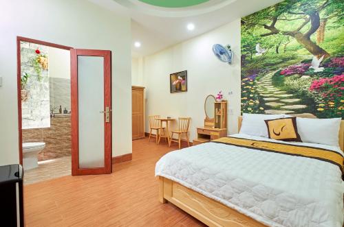 a bedroom with a bed and a painting on the wall at THANH TÙNG HOTEL in Quy Nhon