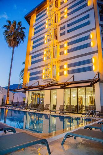a hotel with a swimming pool in front of a building at Sette Serenity Hotel in Alanya