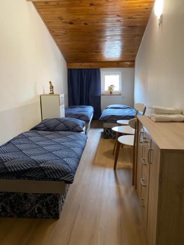a dorm room with three beds and a desk at Penzion U Martina in Mariánské Lázně