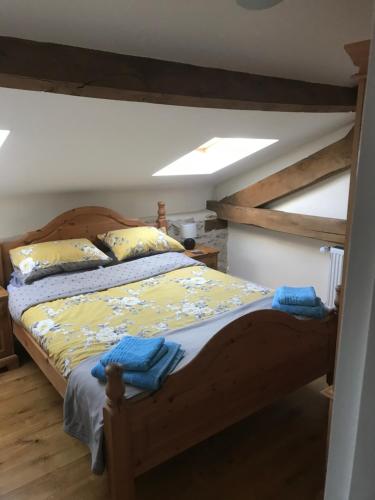 a bedroom with a bed with a wooden bed frame at Maison Tranquille in Champniers-et-Reilhac