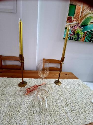 a table with two wine glasses and a wine at Mol Hahr in Safed