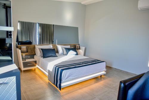 a bedroom with a large bed with blue pillows at Sette Serenity Hotel in Alanya