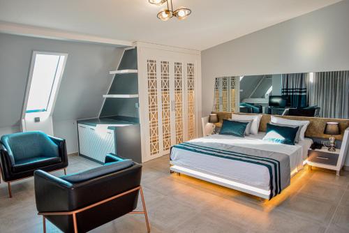 a bedroom with a bed and a desk and a chair at Sette Serenity Hotel in Alanya