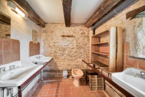 een badkamer met 2 wastafels en een toilet bij Maison de 4 chambres avec terrasse amenagee et wifi a Gavaudun in Gavaudun