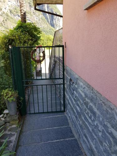 an open gate to a house with a stairway at Casa Di Vacanza Cevio in Cevio