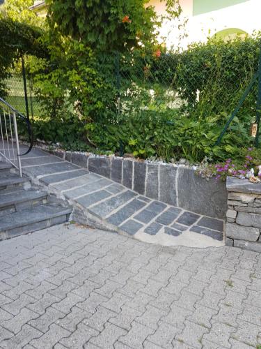 a set of concrete steps with a fence and flowers at Casa Di Vacanza Cevio in Cevio