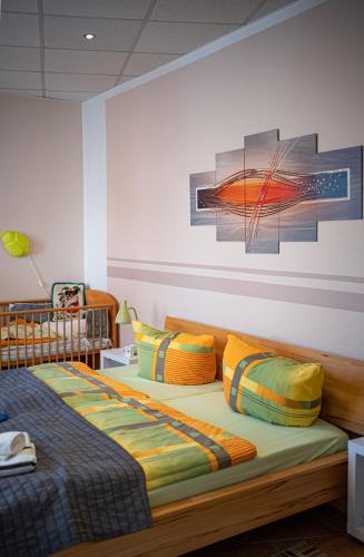 a bedroom with a bed with colorful pillows at am Erxleben-Hotel in Quedlinburg