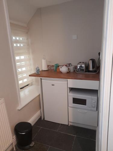 a small kitchen with a counter top and a sink at The Raven Inn in Ruthin