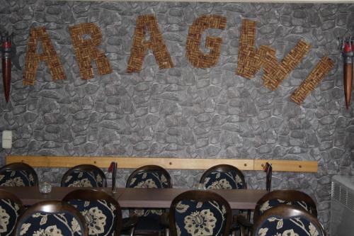 a stone wall with a sign that reads eat pray worship at Hotel & Restaurant Aragwi in Salzwedel