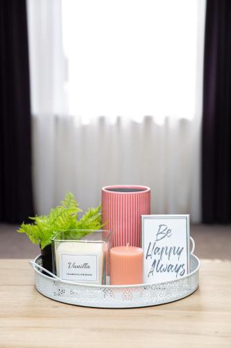 a tray with candles and other items on a table at Žvejo kiemelis in Šilutė
