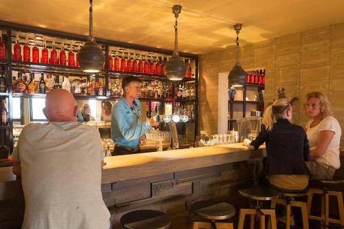 a group of people sitting at a bar at Hotel Lands End in Den Helder