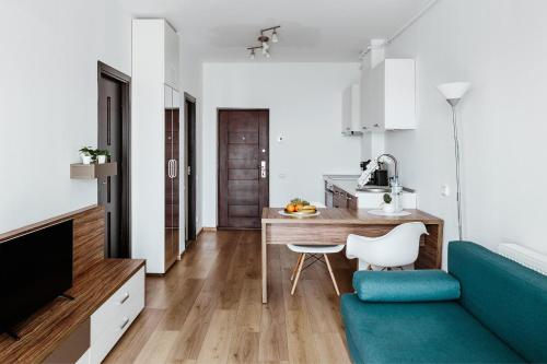 a living room with a blue couch and a table at DD Apartments in Cluj-Napoca